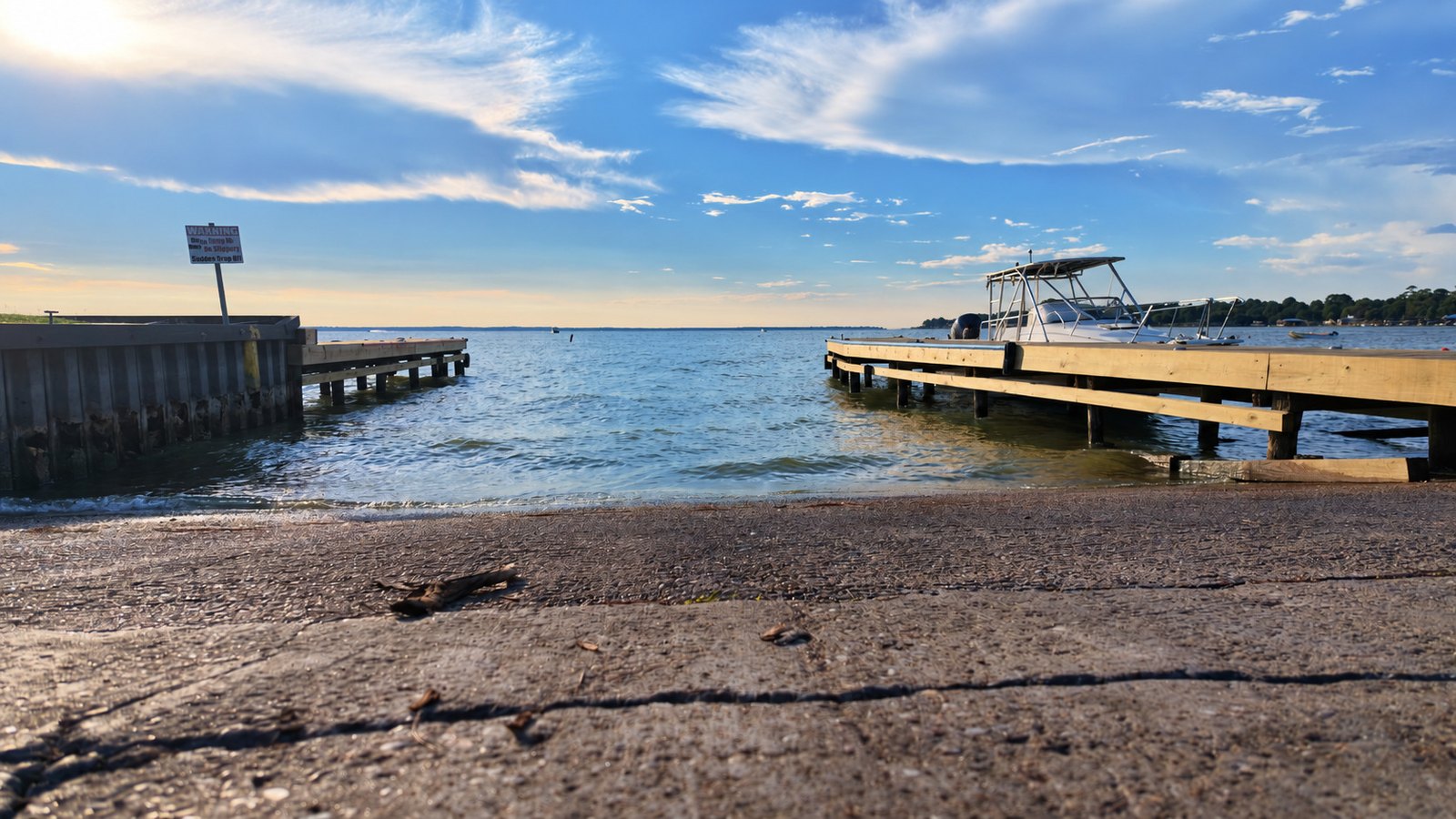 Concrete boat ramp at Blanchard on Lake Livingston, with the older bulkhead pier at left and a new wooden dock at right.