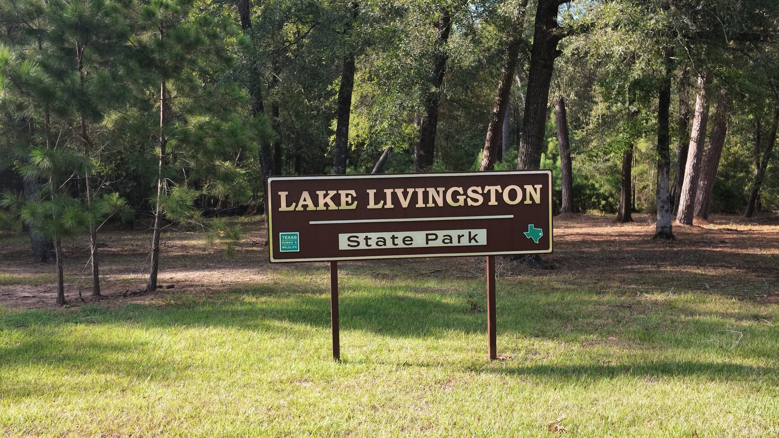 Brown Texas Parks and Wildlife entrance sign reading Lake Livingston State Park.